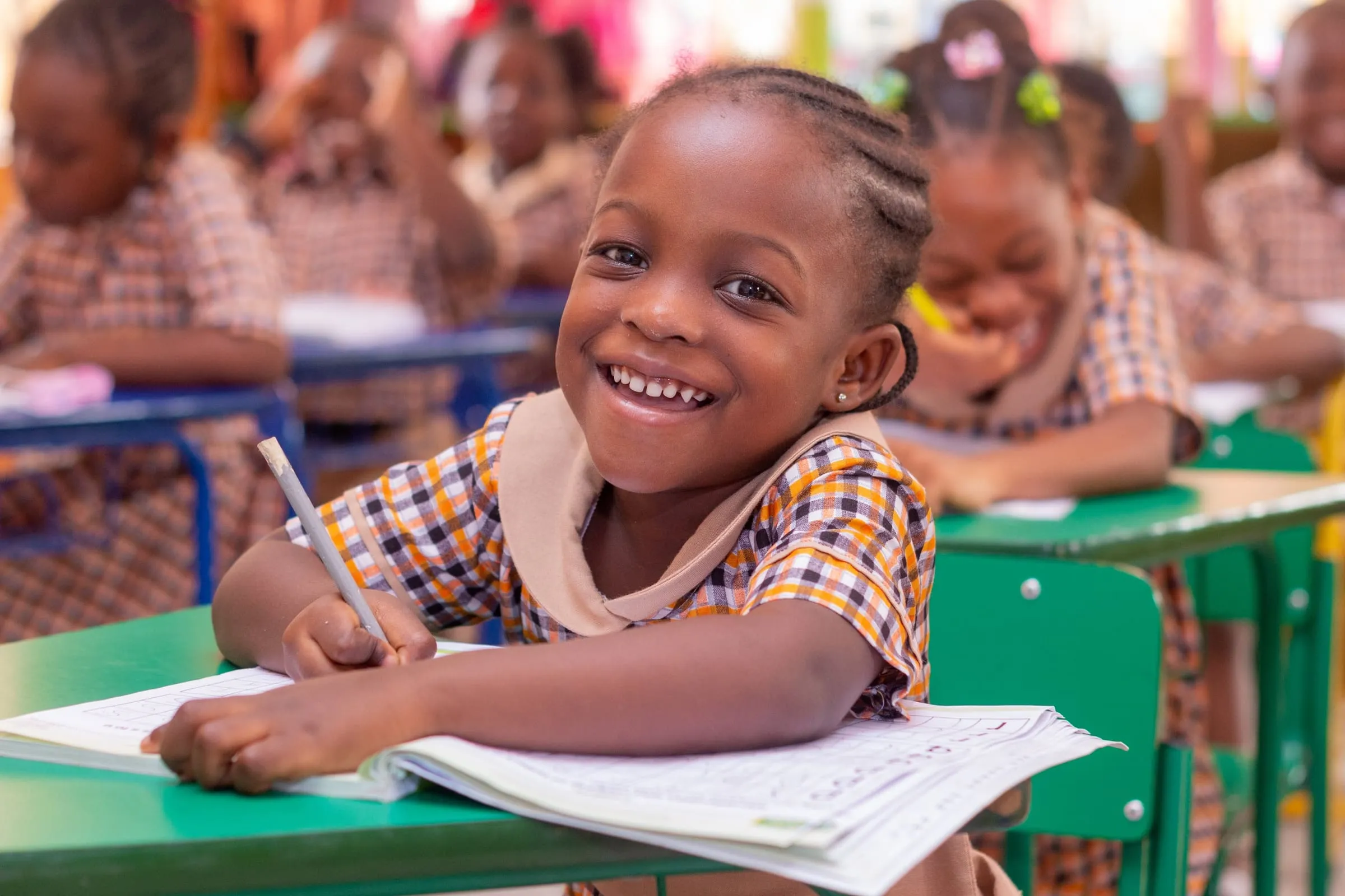 A Crystal Heights iPrimary pupil looking up from her workbook in class