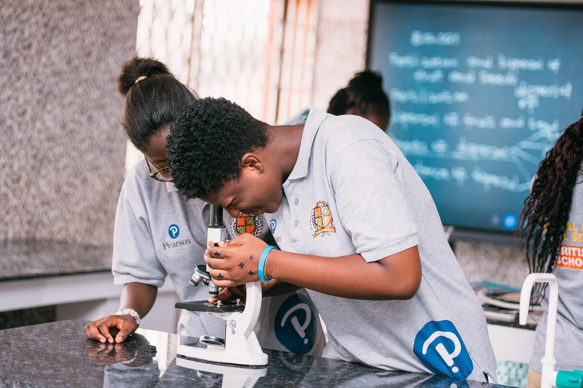 Students at a microscope in the science laboratory