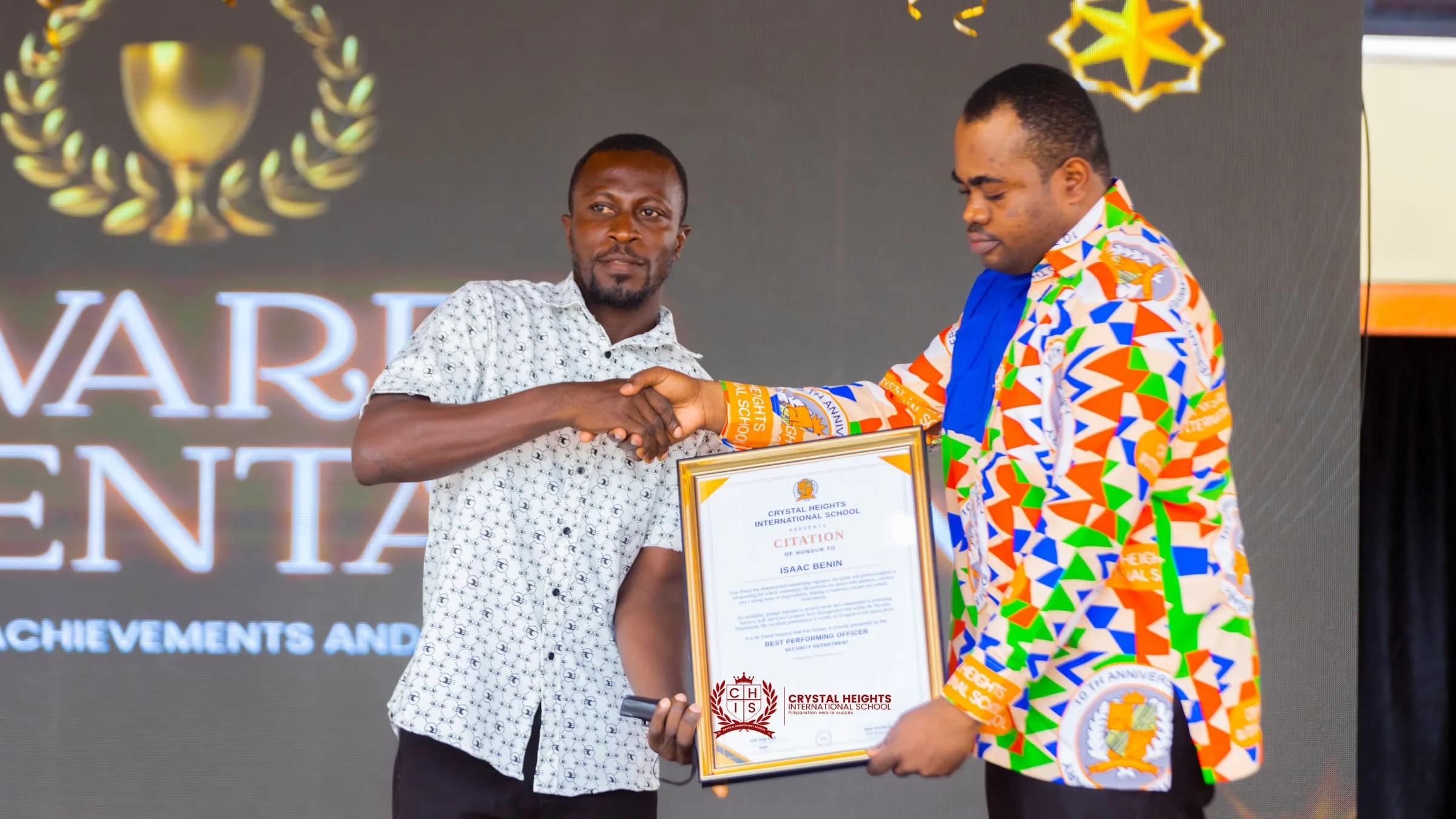 A framed citation presented to a member of staff at Speech and Prize Giving